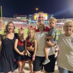 Photo of Dr. Lewis and his family at a football game