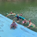Photo of Dr. Lewis swimming with his family