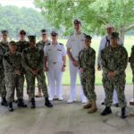 Photo of Dr. Lewis and others in navy uniforms