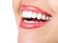 Woman smiling with straight teeth after clear braces