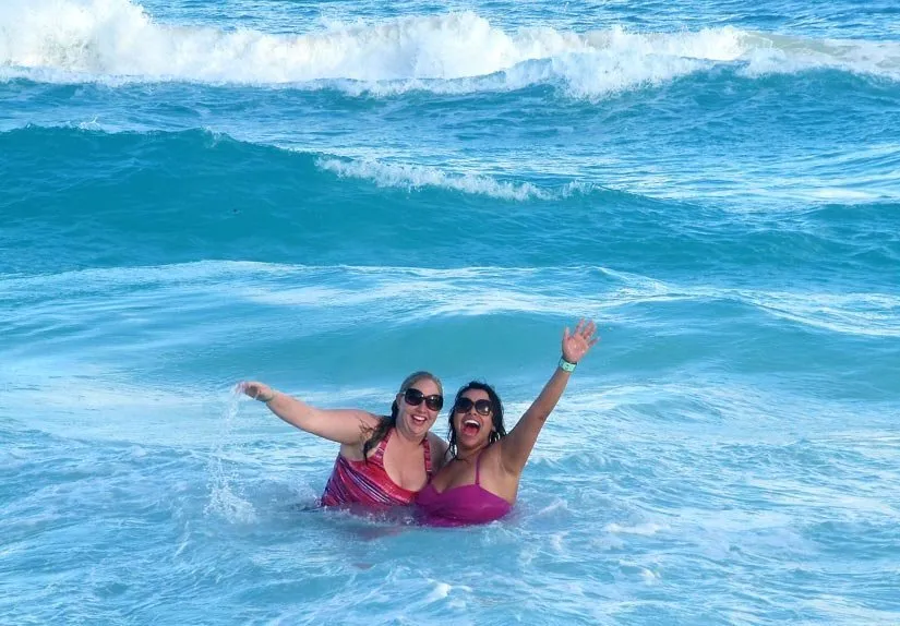 Staff members in the water at the beach