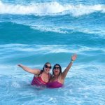 Staff members in the water at the beach