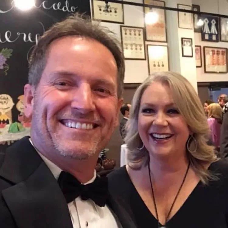 Dr. Grimes in a tux with his wife